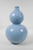 A Chinese blue glazed porcelain double gourd vase, with all over raised gourd vine decoration,