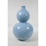 A Chinese blue glazed porcelain double gourd vase, with all over raised gourd vine decoration,