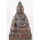 A Sino Tibetan bronze figure of a deity seated in meditation, 11½" high