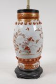A Japanese Meiji period satsuma pottery vase decorated with flowers and butterflies, converted to