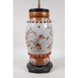 A Japanese Meiji period satsuma pottery vase decorated with flowers and butterflies, converted to