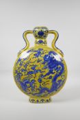 A Chinese yellow ground porcelain two handled moon flask with blue and white dragon and phoenix