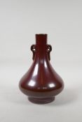 A copper lustre glazed porcelain two handled vase, impressed Chinese Qianlong seal mark to base, 8½"