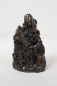 A Chinese faux horn carving of a mountain landscape with figures, carved character mark to base, 7½"