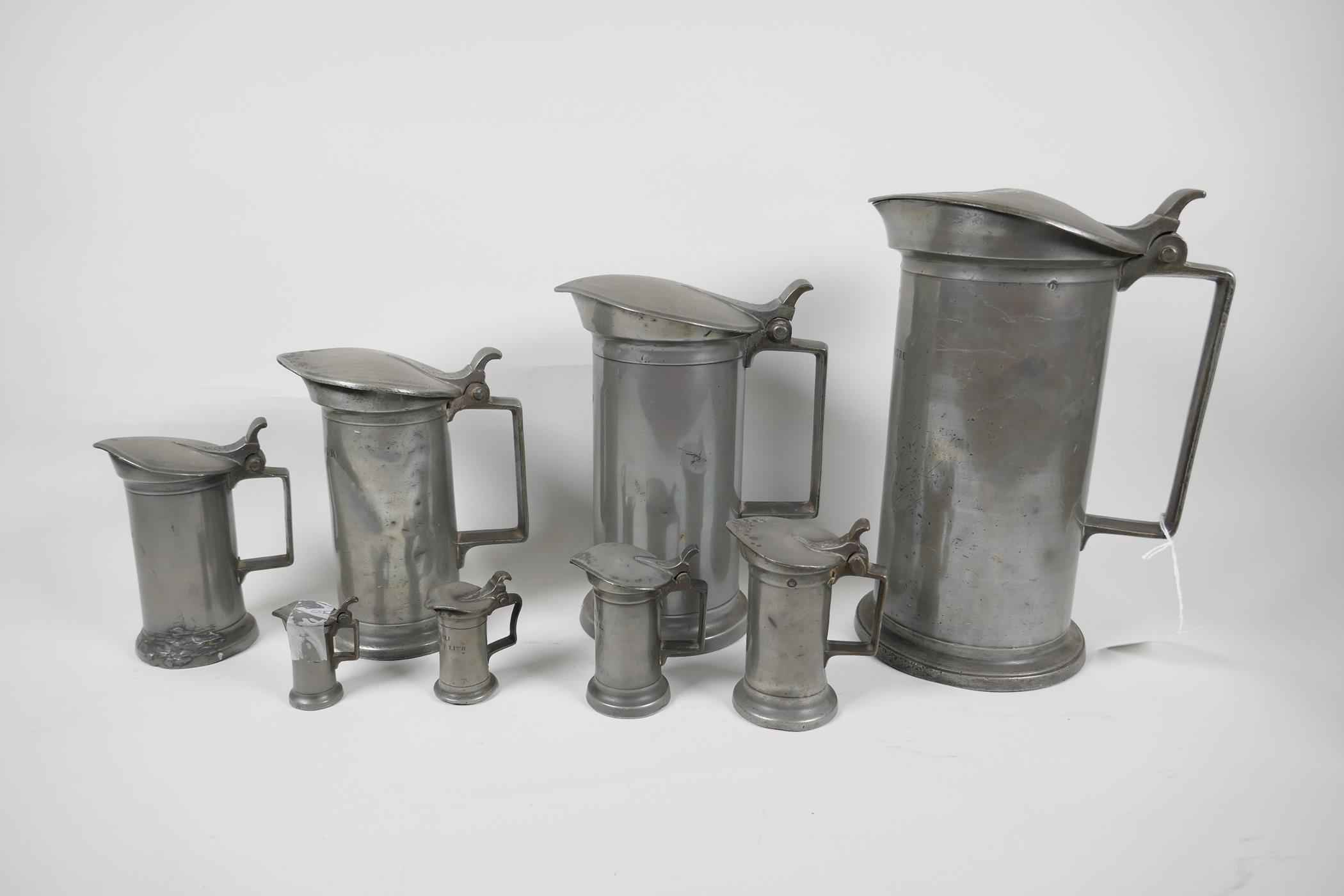 A set of eight C19th French pewter measures by Bazire, 21ltr to 1centilitre, largest 10" high