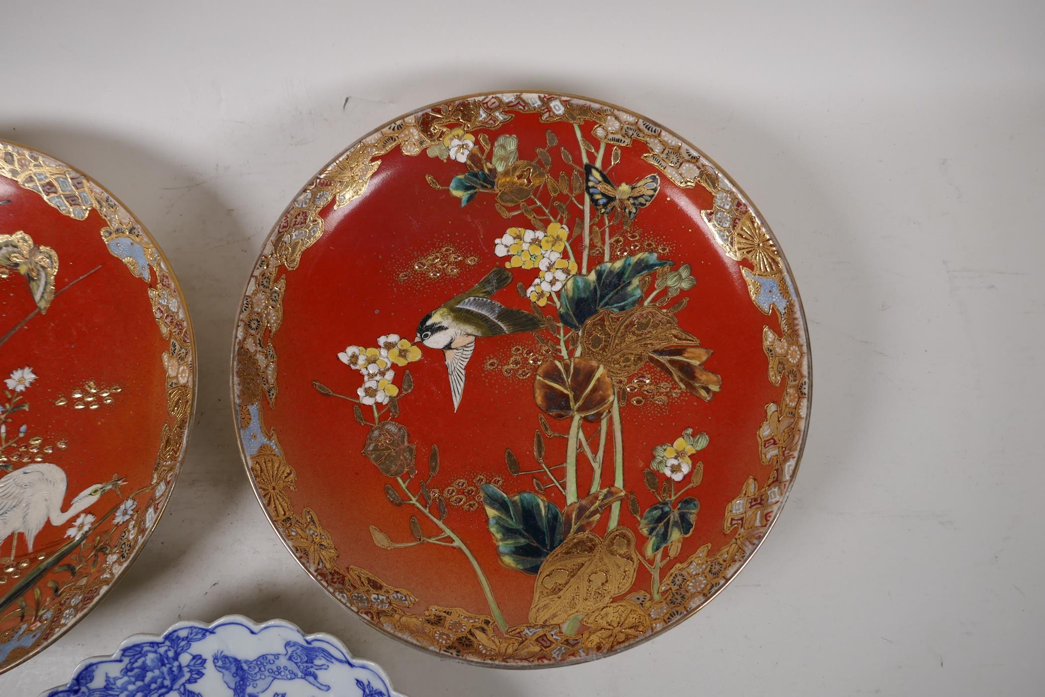 A pair of Japanese red ground pottery cabinet plates with satsuma decoration depicting birds amongst - Image 3 of 4