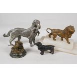 A bronze figure of a gundog with retrieved bird, 8" long, a bronze figure of a spaniel, a bronzed