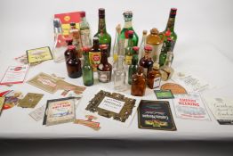 A collection of miniature bottles and a quantity of bottle labels