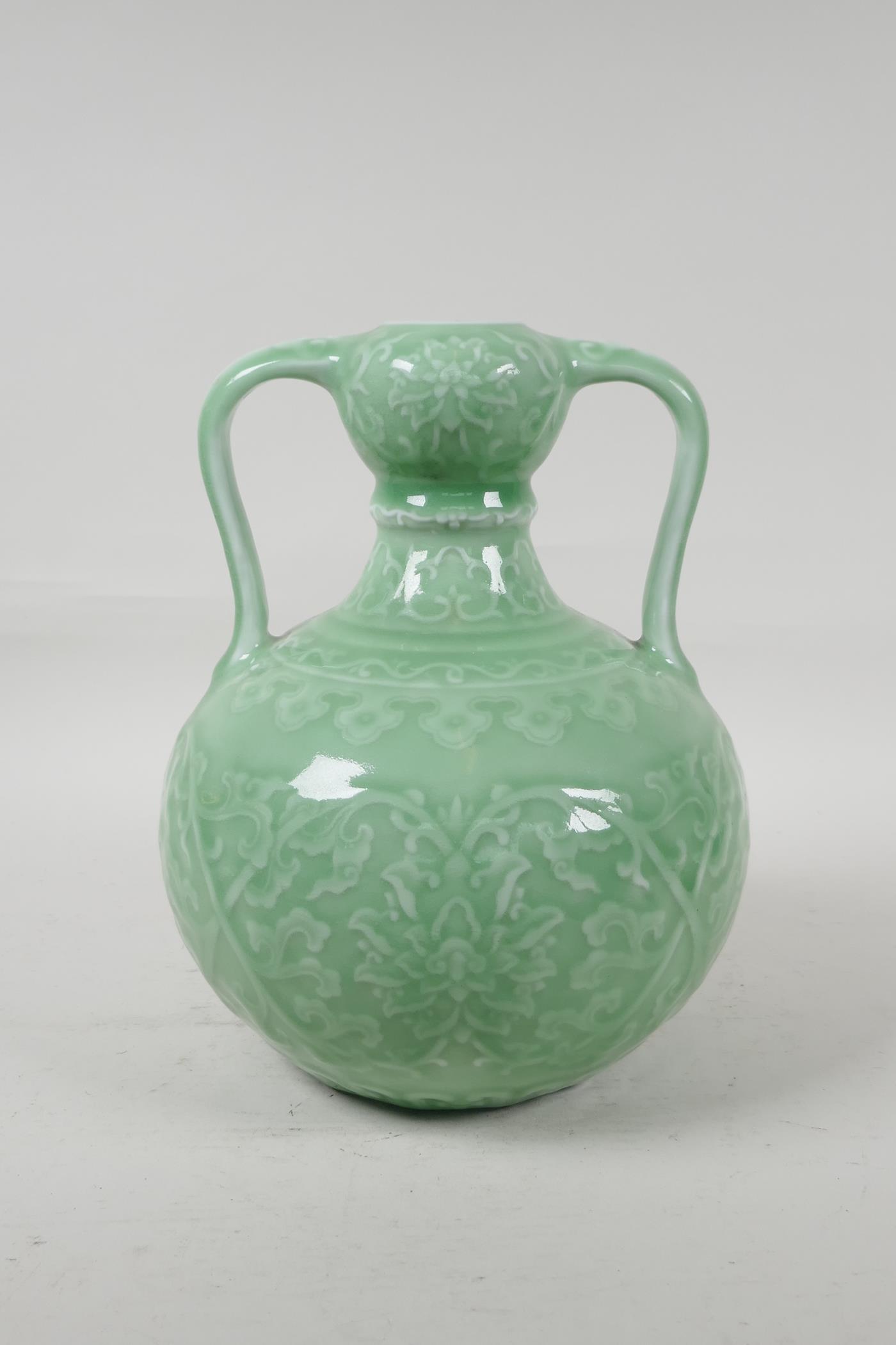 A Chinese green glazed porcelain garlic head vase, with underglaze lotus flower decoration, seal