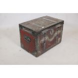 An early C19th painted leather trunk with brass stud decoration and steel straps, original papered