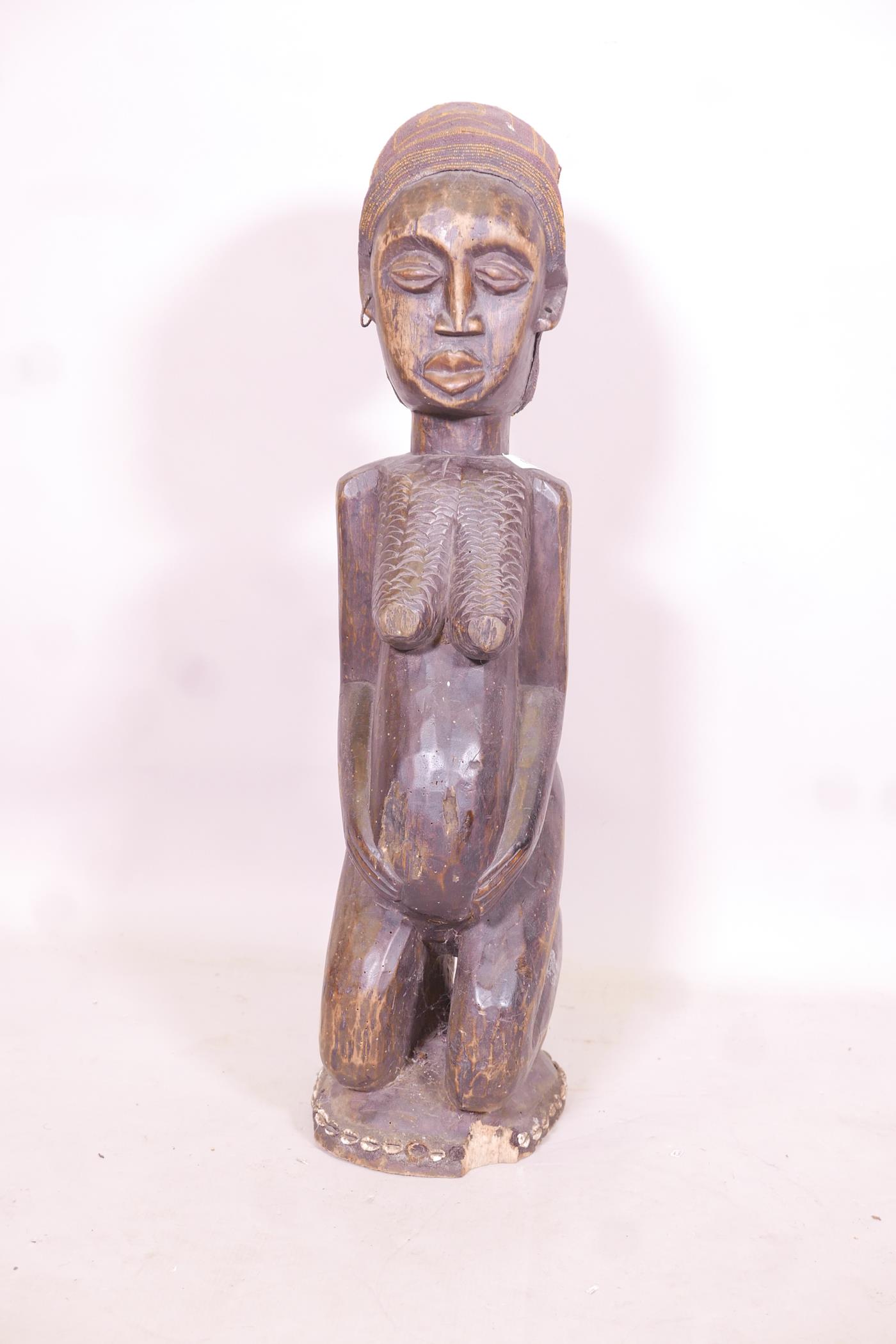 An antique African carved wood fertility figure with beaded headdress and inset with sea shells, - Image 3 of 5