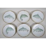 A set of six German 'Thomas' porcelain fish plates with shaped and gilt rims, 9" diameter