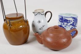 A Chinese Yixing redware teapot, 7" long, an early sparrow beak jug, an oriental storage jar and