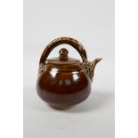 A Chinese treacle glazed teapot, 5" high