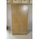 A mid century enamelled metal two door storage cupboard, 35" x 18", 71" high