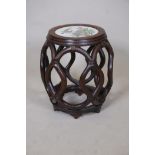 A Chinese carved hardwood bamboo lattice style jardiniere stand, the top inset with a polychrome