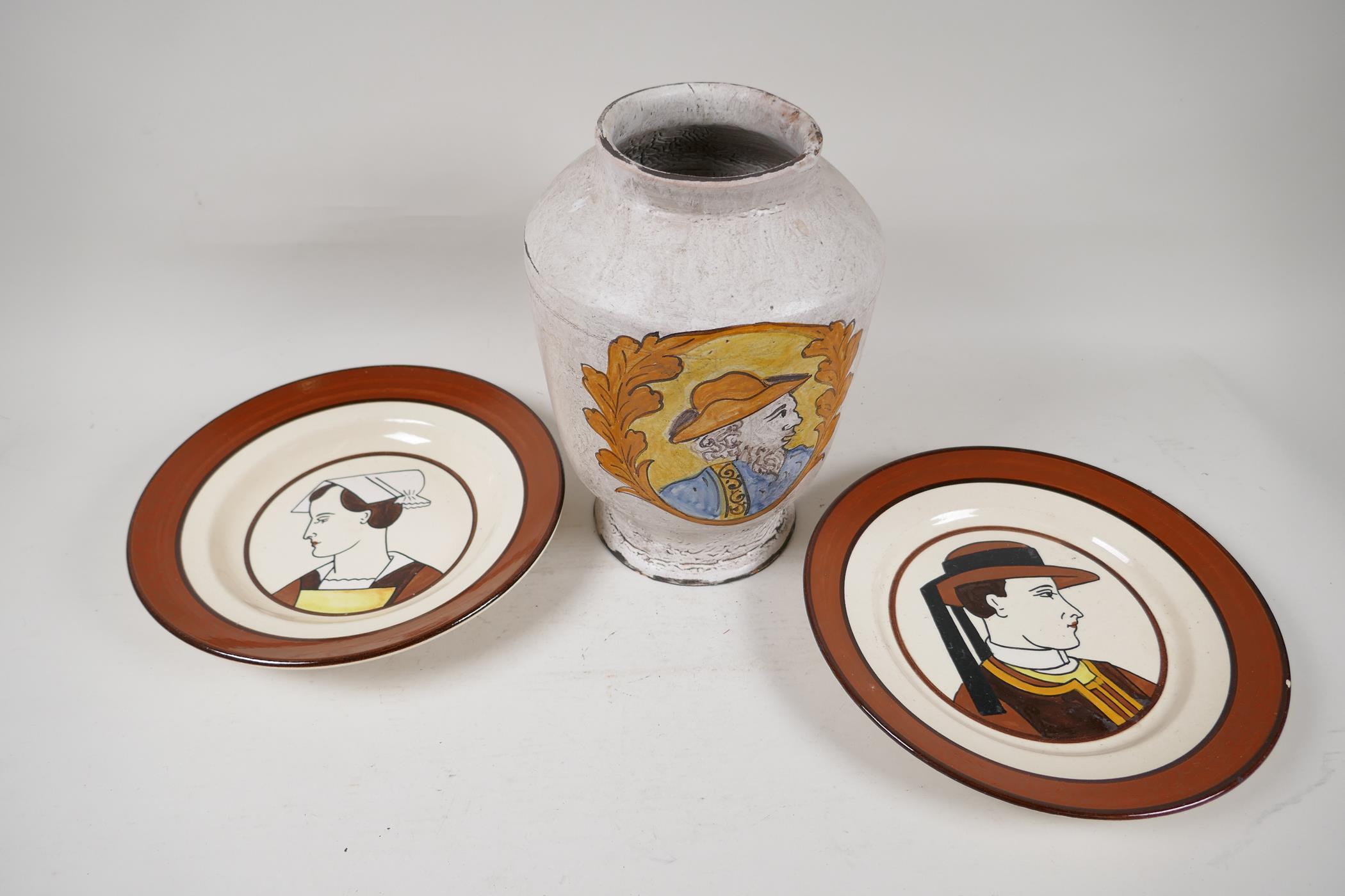 A pair of decorative Quimper wall plates, traditionally painted with a Breton couple, 9" diameter,