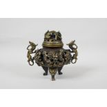 A Chinese bronzed metal censer and cover with two dragon handles and pierced dragon decoration,