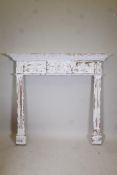 A Victorian painted pine fire surround with fluted columns and applied carved wood clamshell and