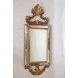 A Venetian painted and giltwood cushion shaped wall mirror, early C20th, 35" x 14"