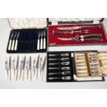 A George Butler stag horn handled carving set, boxed, together with two boxed sets of cake forks,