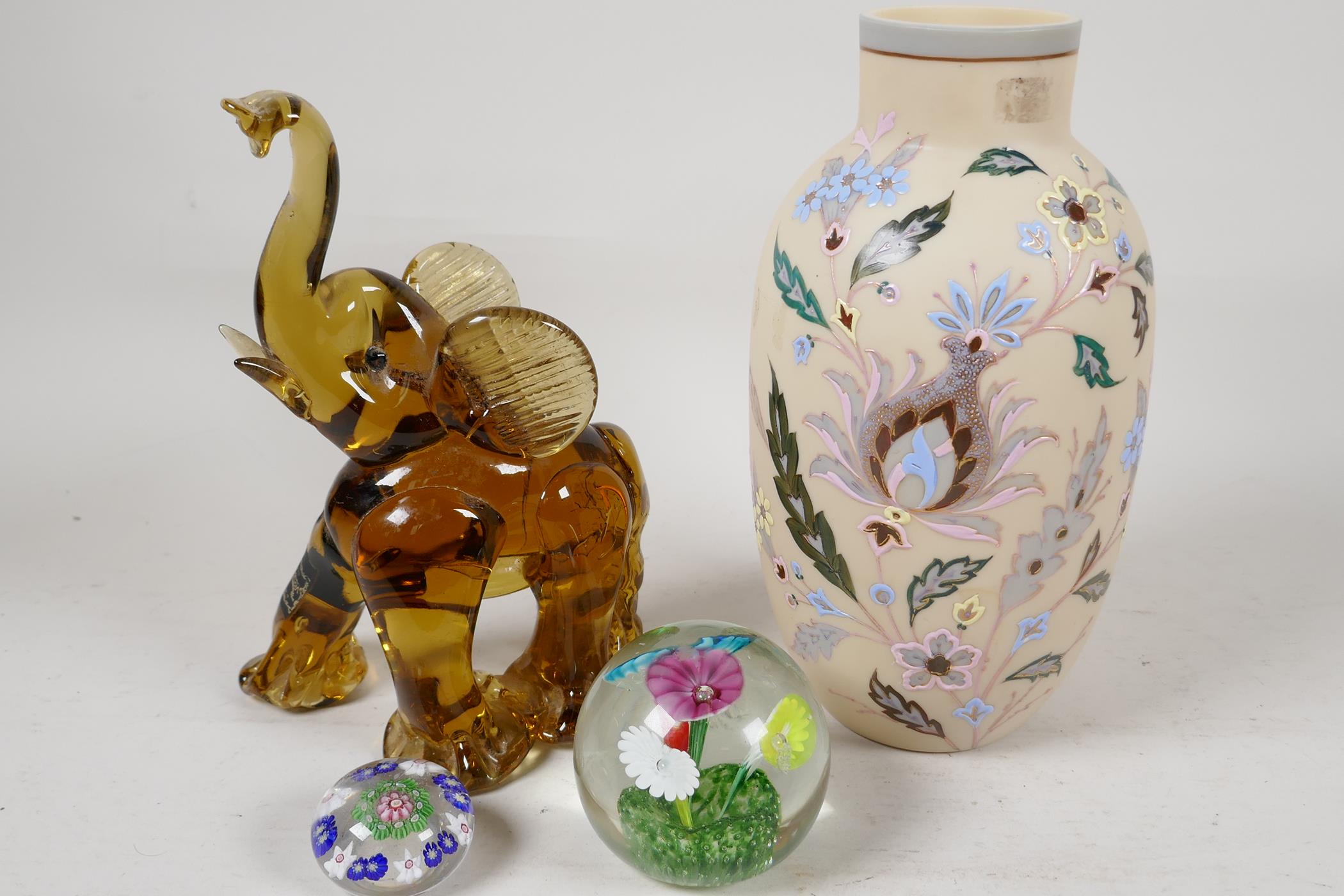 A C19th milk glass vase painted with flowers, 9" high, a Murano glass figure of an elephant and