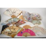 A collection of twelve painted paper fans, Spanish and oriental, and a bone and silk fan, mainly