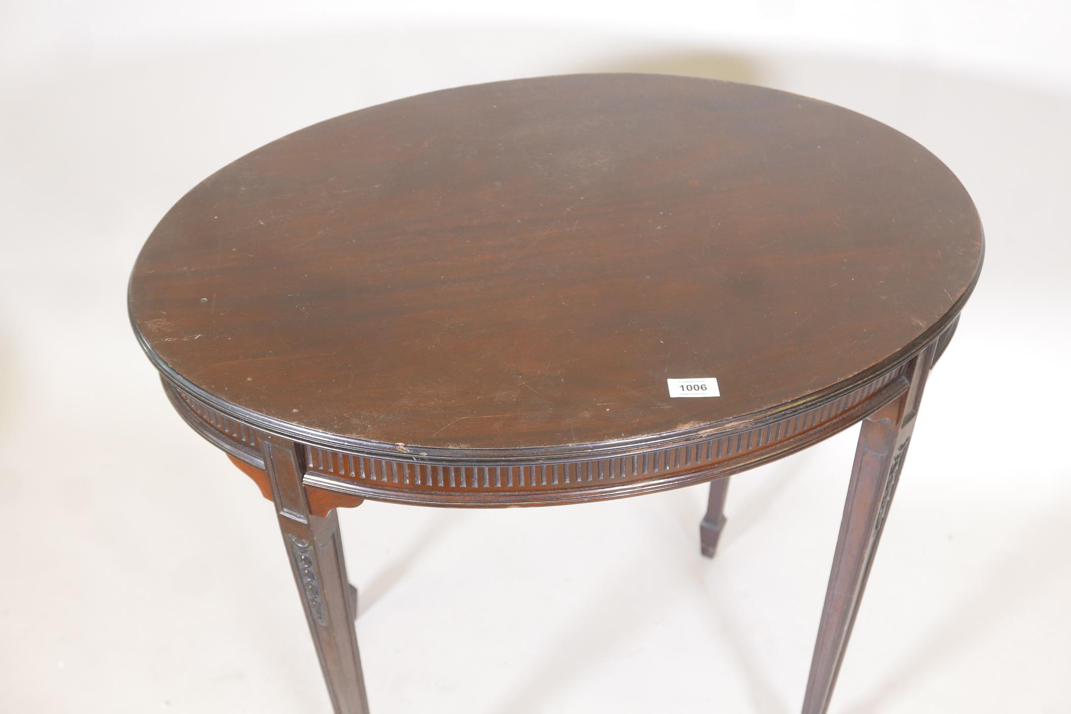 An Edwardian Adam style mahogany oval shaped occasional table, with reeded frieze and carved - Image 2 of 3