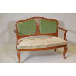 An early C20th Danish inlaid solid satinwood canape and matching chair with a pierced splat back,