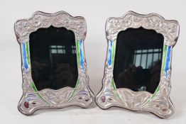 A pair of Art Nouveau style silver and enamel photo frames, aperture 4" x 6"