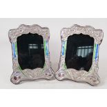 A pair of Art Nouveau style silver and enamel photo frames, aperture 4" x 6"