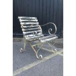 An antique painted garden chair with wrought iron scroll ends