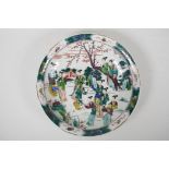 A famille vert porcelain dish decorated with women in a garden, Chinese Kangxi character mark to