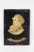 An antique bronze portrait plaque of Charles Dickens, mounted on a velvet covered panel, 9" x 12"