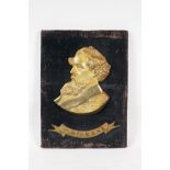 An antique bronze portrait plaque of Charles Dickens, mounted on a velvet covered panel, 9" x 12"