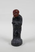A Chinese carved Zitan wood figure of Lohan with soapstone head, 6" high