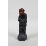 A Chinese carved Zitan wood figure of Lohan with soapstone head, 6" high