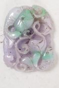 A Chinese jade pendant roundel carved with fish, 3" long