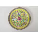 A Chinese polychrome porcelain cabinet dish with floral decoration on a yellow ground, Qianlong mark