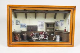 A Triumph motorcycle workshop diorama, 14" x 4", 8½" high