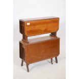 An Edwardian mahogany two tier drop leaf occasional table, with satinwood banded tops, raised on