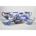 Six blue and white transfer printed jugs and three gravy boats, various patterns, largest 6" high