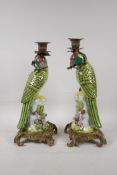 A pair of brightly enamelled porcelain and gilt metal parakeet candlesticks, 13½" high