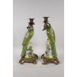 A pair of brightly enamelled porcelain and gilt metal parakeet candlesticks, 13½" high