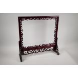 A Chinese carved and pierced hardwood table screen frame, aperture 17" x 13"