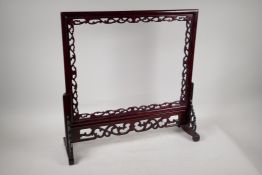 A Chinese carved and pierced hardwood table screen frame, aperture 17" x 13"