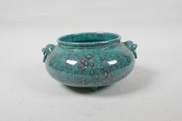 A robin's egg glazed porcelain censer with two mask handles and tripod supports, indistinct seal
