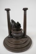A bronze stand cast as two classical figures looking into a well, 10" diameter, 11" high