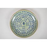 A Chinese celadon crackle glazed dish with allover blue and white character inscription