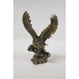 A filled bronze figure of an eagle, impressed Chinese four character mark to base, 8" high